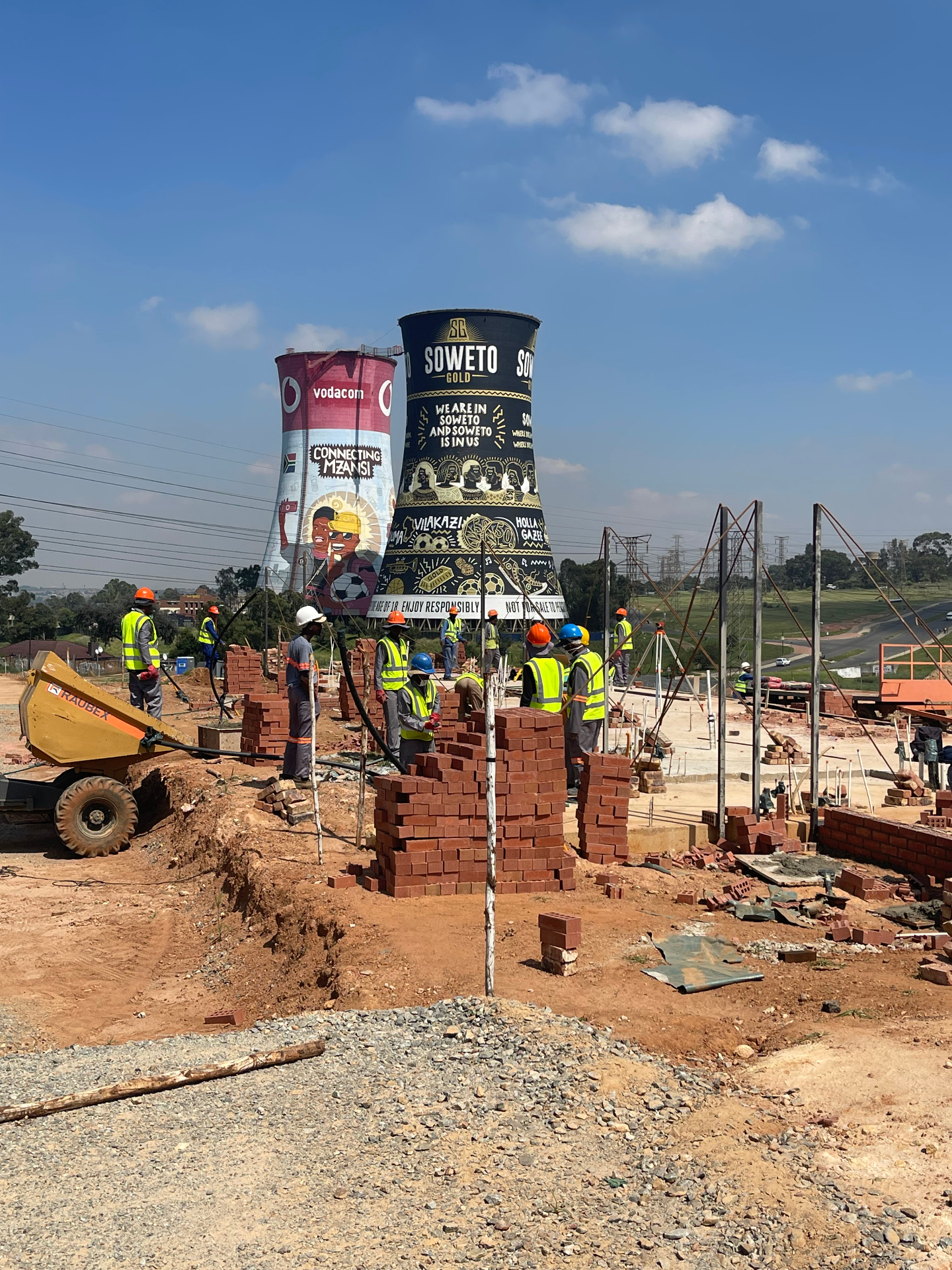 Bricklaying teams on site with the Orlando Towers in view