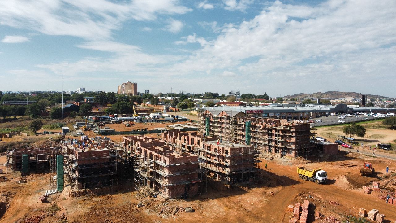 Aerial view of construction progress with Shoprite centre in the background
