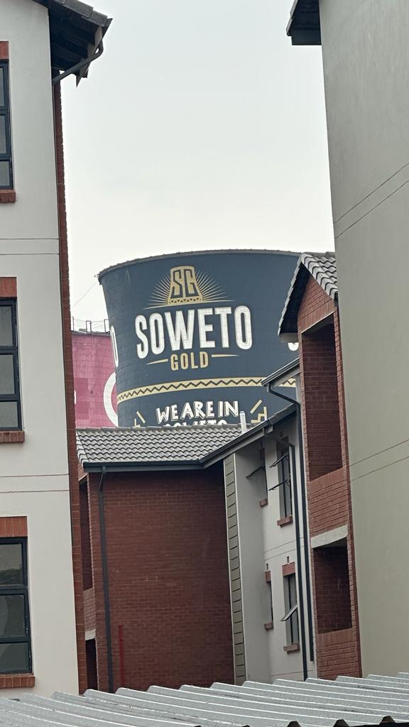 View of the Soweto Gold tower between estate buildings